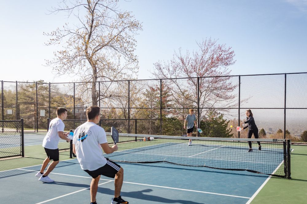 A group of four individuals playing in a pickleball tournament.