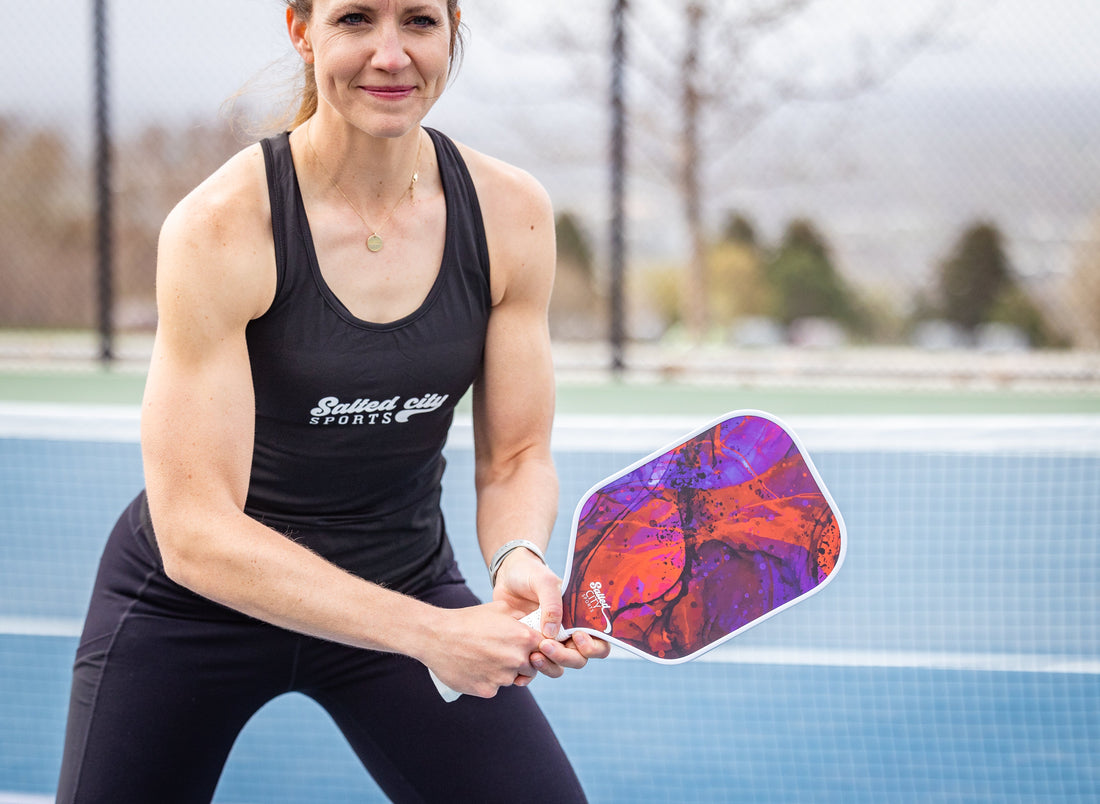 Pickleball player holding a pickleball paddle