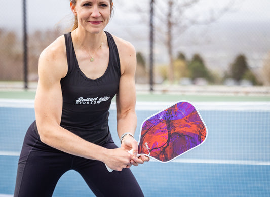 Pickleball player holding a pickleball paddle