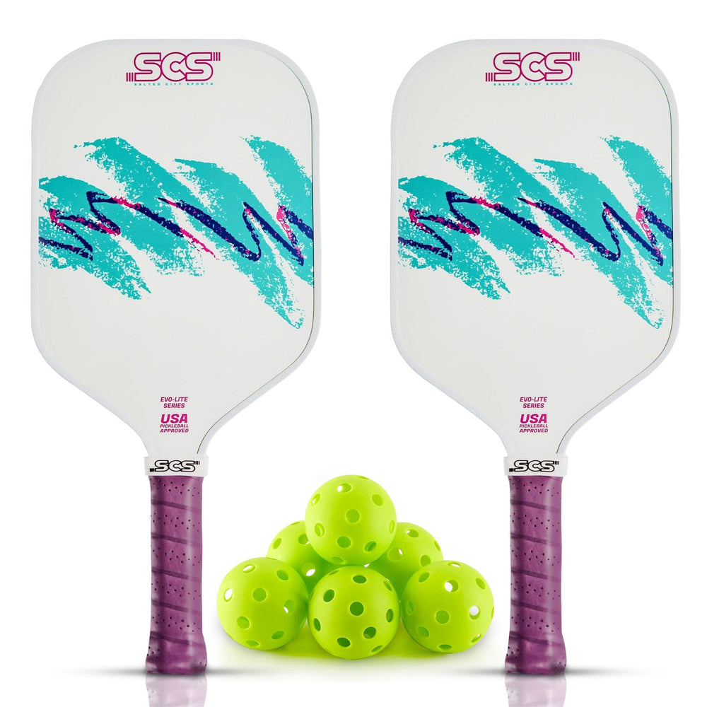Two pickleball paddles with a stack of green pickleballs
